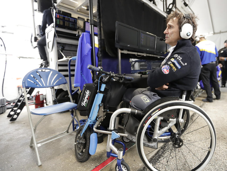 Alex Zanardi watches a video monitor in his pit stall during a practice session for the IMSA 24 hour race at Daytona International Speedway, Thursday, Jan. 24, 2019, in Daytona Beach, Fla. (AP Photo/John Raoux)