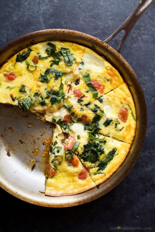 <p>Roasted tomato caprese frittata, an easy yet fancy looking holiday recipe that's perfect for brunch! Filled with melted mozzarella, fresh basil, garlic infused spinach and roasted tomato - it's pretty much divine!</p><p><a href="http://www.joyfulhealthyeats.com/roasted-tomato-caprese-frittata/" rel="nofollow noopener" target="_blank" data-ylk="slk:Get the recipe here!;elm:context_link;itc:0;sec:content-canvas" class="link rapid-noclick-resp"><em><strong>Get the recipe here!</strong></em></a></p>