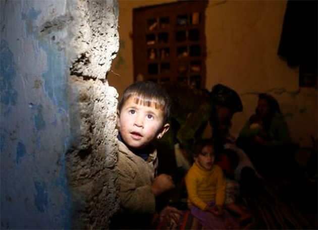 A Kurdish refugee boy from the Syrian town of Kobani looks out from a small room where he lives with his family in the southeastern town of Suruc, Sanliurfa province. Photo: Reuters