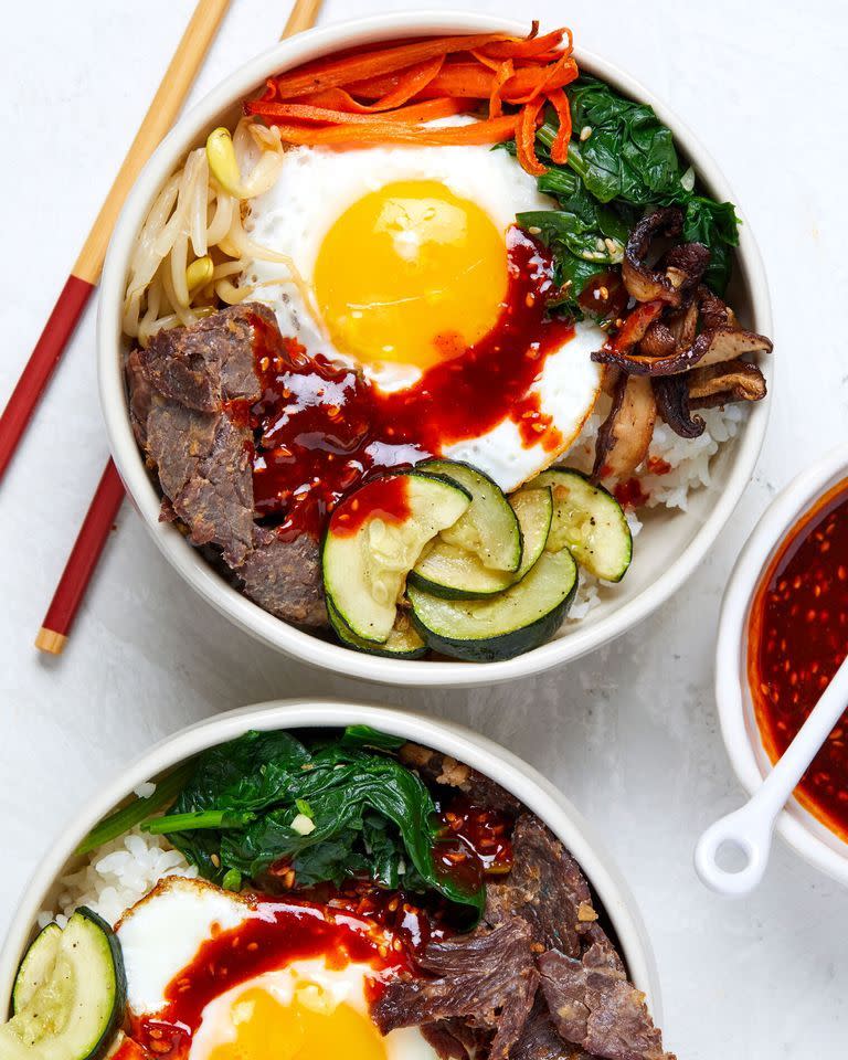 <p>In Korean, <em>bibimbap</em> literally means "mixed <a href="https://www.delish.com/cooking/a20089653/how-to-cook-rice/" rel="nofollow noopener" target="_blank" data-ylk="slk:rice;elm:context_link;itc:0;sec:content-canvas" class="link ">rice</a>." It usually features white rice crowned with different types of meat and vegetable-based toppings—all individually prepared in a separate cooking vessel. This recipe, however, calls for cooking the toppings on a single <a href="https://www.delish.com/cooking/g4267/sheet-pan-dinners/" rel="nofollow noopener" target="_blank" data-ylk="slk:sheet tray,;elm:context_link;itc:0;sec:content-canvas" class="link ">sheet tray,</a> which eliminates much of that work.</p><p>Get the <strong><a href="https://www.delish.com/cooking/recipe-ideas/a36007712/sheet-pan-bibimbap-recipe/" rel="nofollow noopener" target="_blank" data-ylk="slk:Sheet Pan Bibimbap recipe;elm:context_link;itc:0;sec:content-canvas" class="link ">Sheet Pan Bibimbap recipe</a></strong>.</p>