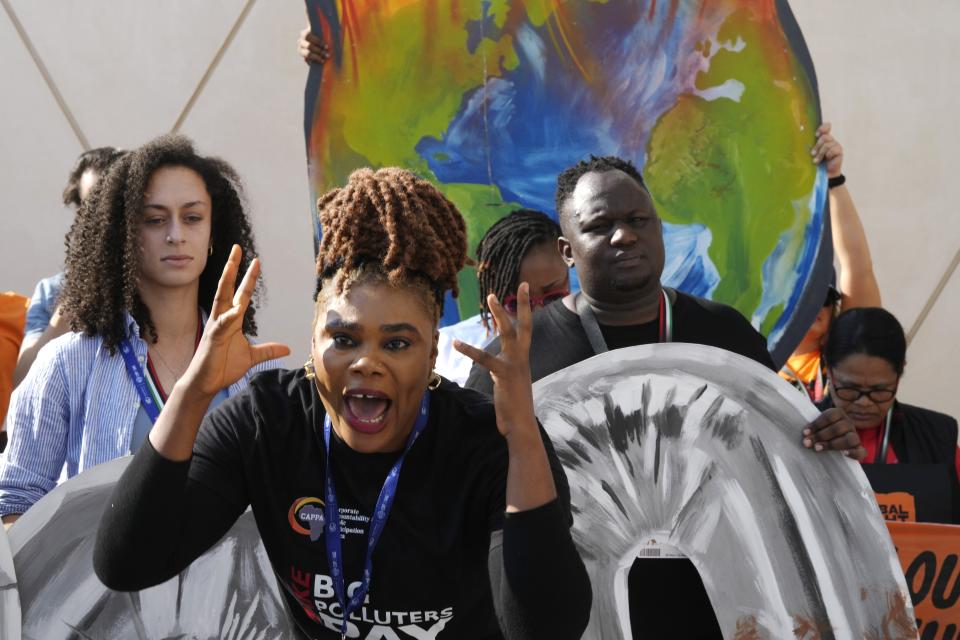 An activist shouts while participating in a protest at the COP28 U.N. Climate Summit, Tuesday, Dec. 5, 2023, in Dubai, United Arab Emirates. (AP Photo/Peter Dejong)