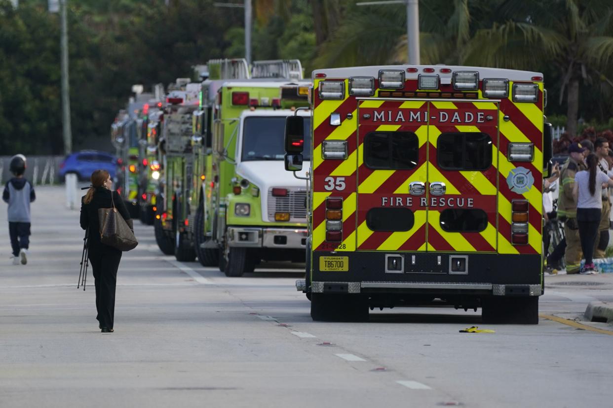 A line of emergency vehicles line the streets near the site of a partial building collapse, Thursday, June 24, 2021, in Surfside, Fla.