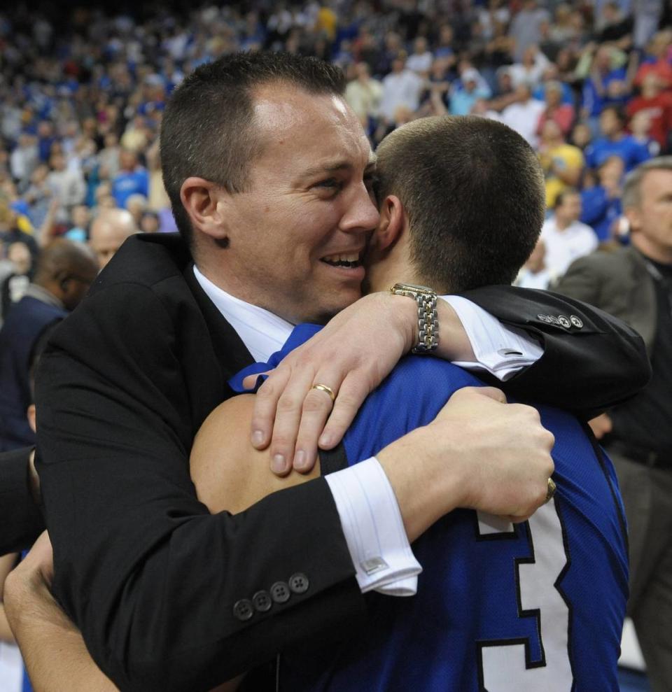 Shelby Valley coach Jason Booher, left, gives state tournament MVP Elisha Justice a hug after the Wildcats defeated Ballard 73-61 at Rupp Arena in the 2010 finals.