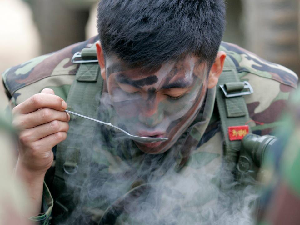 A South Korean marine eats dinner during a military drill against possible attacks by North Korea.