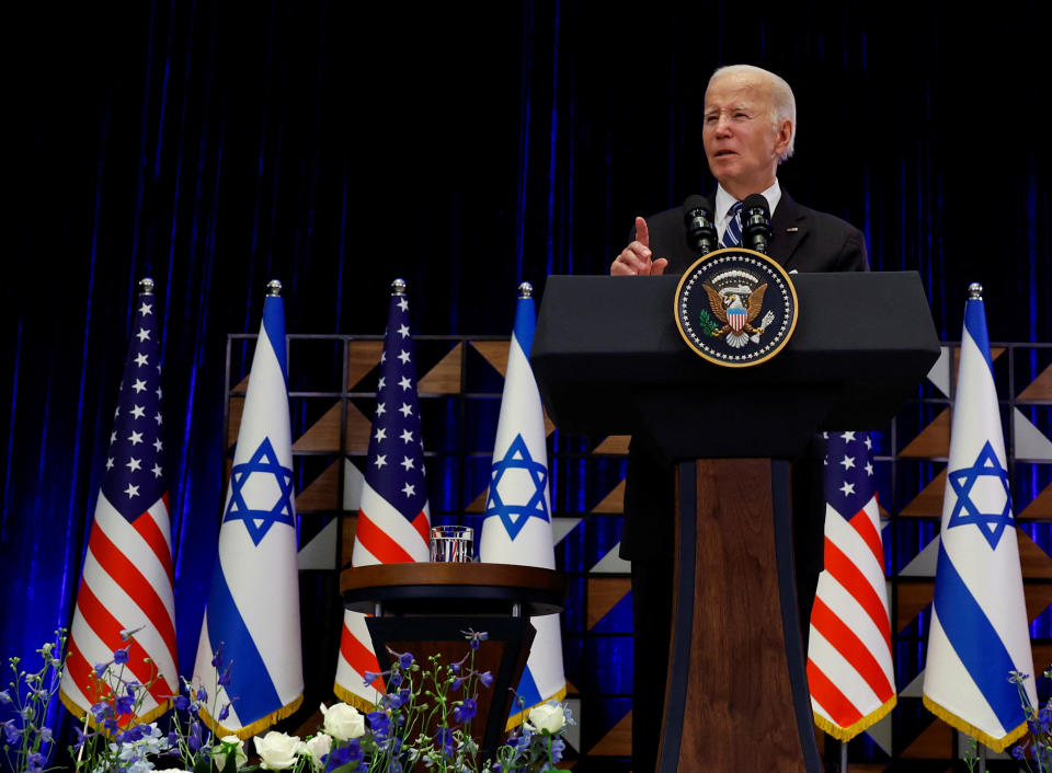President Biden stands at a podium and delivers remarks in Tel Aviv.