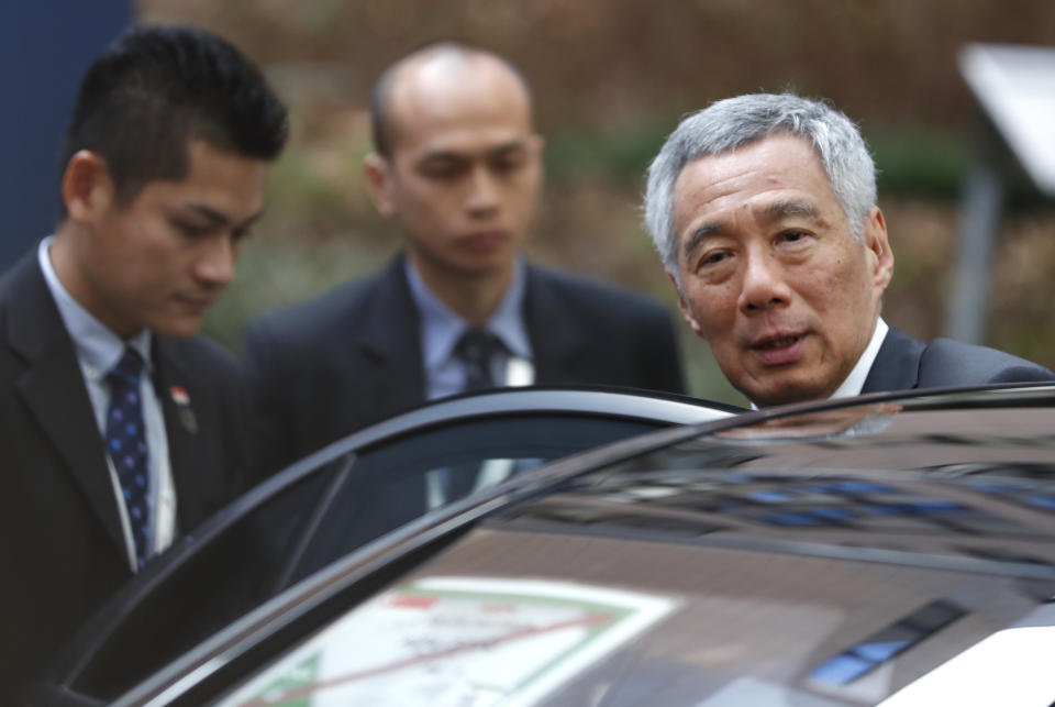 Singapore's Prime Minister Lee Hsien Loong departs at the end of an EU-ASEM summit in Brussels, Friday, Oct. 19, 2018. EU leaders met with their Asian counterparts Friday to discuss trade, among other issues. (AP Photo/Alastair Grant)