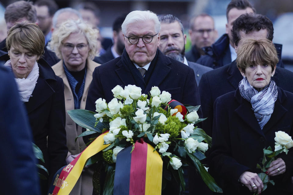 German president Frank-Walter Steinmeier, his wife Elke Buedenbender, left, and governor Volker Bouffier aarive to lay flowers at the hookah bar where several people were killed in Hanau, Germany, Thursday, Feb. 20, 2020. A 43-year-old German man shot and killed several people in different locations in a Frankfurt suburb overnight in attacks that appear to have been motivated by far-right beliefs, officials said Thursday. (Uwe Anspach/DPA via AP)