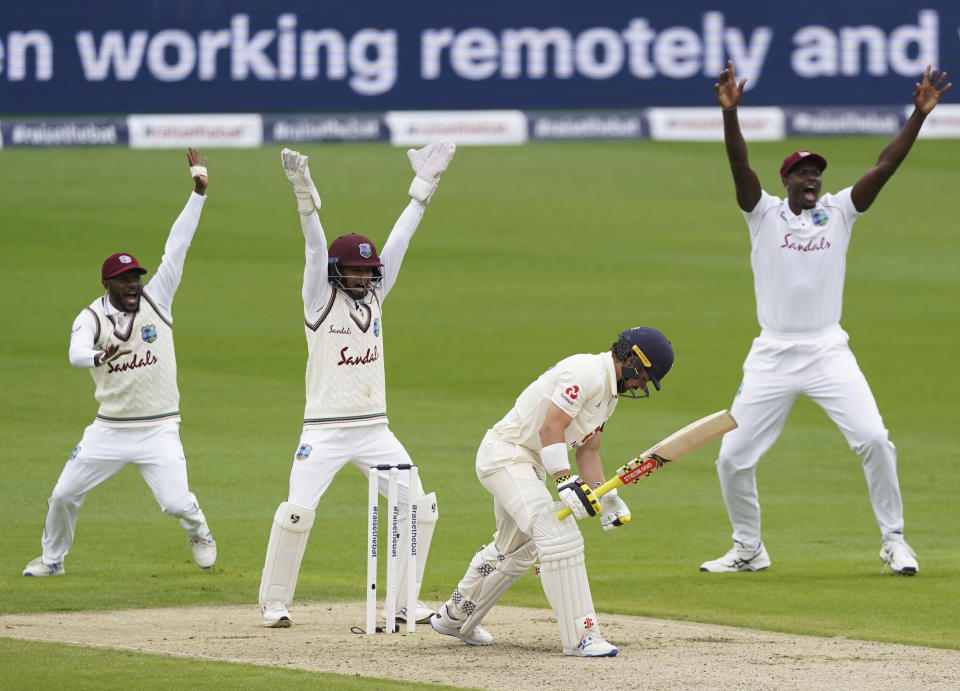 West Indies players appeal successfully for the wicket of England's Rory Burns, second right, during the first day of the second cricket Test match between England and West Indies at Old Trafford in Manchester, England, Thursday, July 16, 2020. (AP Photo/Jon Super, Pool)