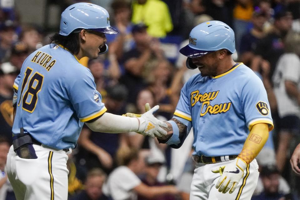 Milwaukee Brewers' Kolten Wong is congratulated by Keston Hiura after hitting a two-run home run during the fourth inning of a baseball game against the Pittsburgh Pirates Tuesday, Aug. 30, 2022, in Milwaukee. (AP Photo/Morry Gash)