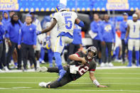 Tampa Bay Buccaneers quarterback Tom Brady (12) slides under Los Angeles Rams cornerback Jalen Ramsey (5) during the second half of an NFL football game Sunday, Sept. 26, 2021, in Inglewood, Calif. (AP Photo/Jae C. Hong )