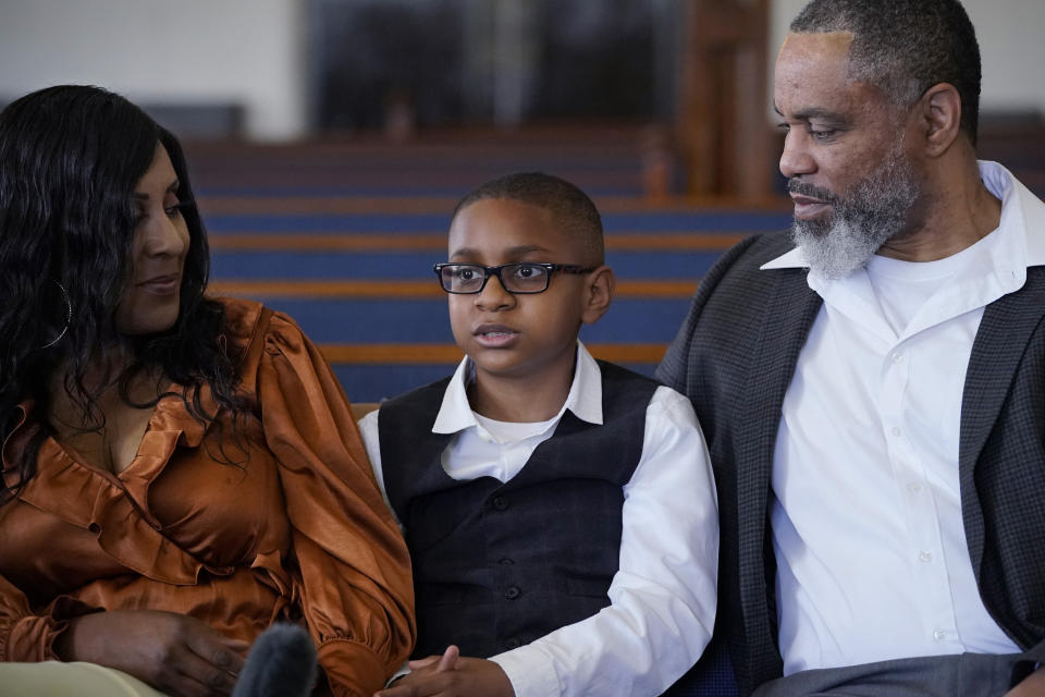 LeRoy "Tripp" Gibbs III, center, 12-year-old great-grandson of Tulsa Race Massacre survivor Ernestine Alpha Gibbs, speaks during an interview with family members in Tulsa, Okla., on Sunday, April 11, 2021. With him are his parents, Tracy and LeRoy Gibbs II. LeRoy II credits his grandmother, who not only built wealth and passed it on, but also showed succeeding generations how it was done. It was a lesson that few descendants of the victims of the race massacre had an opportunity to learn. “The perseverance of it is what she tried to pass on to me,” said LeRoy Gibbs II. AP Photo/Sue Ogrocki)