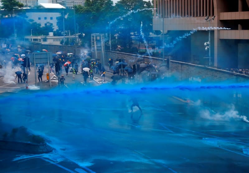 FILE PHOTO: Riot police use water cannon to disperse anti-extradition bill demonstrators during a protest in Hong Kong