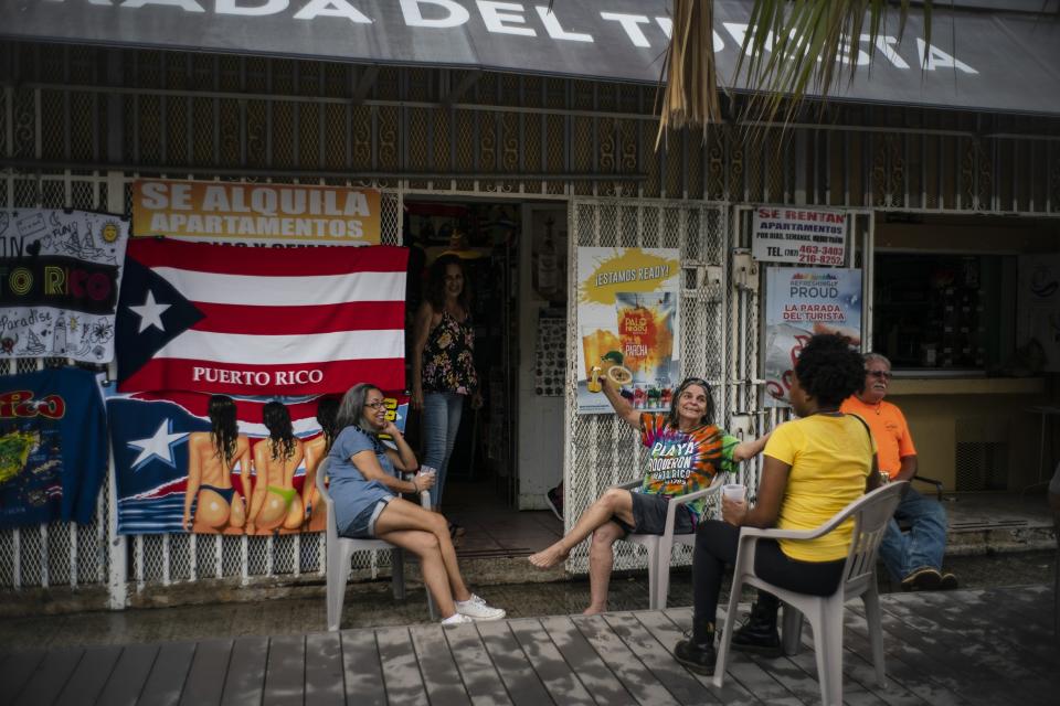 People drink beer on a patio before the arrival of Tropical Storm Dorian in Boqueron, Puerto Rico, Aug. 27, 2019. (Photo: Ramon Espinosa/AP)