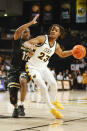 Virginia Commonwealth guard Jayden Nunn (23) drives to the basket as Vanderbilt guard Trey Thomas (12) defends during the first half of an NCAA college basketball game Wednesday, Nov. 30, 2022, in Richmond, Va. (Shaban Athuman/Richmond Times-Dispatch via AP)