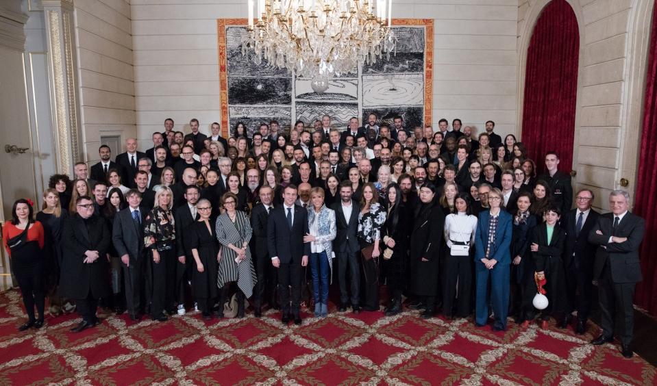 President Emmanuel Macron and his wife, Brigitte, center, host a group of fashion designers and industry executives at the Elysée Palace for a Paris Fashion Week dinner in early March. Abloh is in the second to last row on the right side of the photo. (Photo: Soazig de la Moissonnière/Présidence de la République)