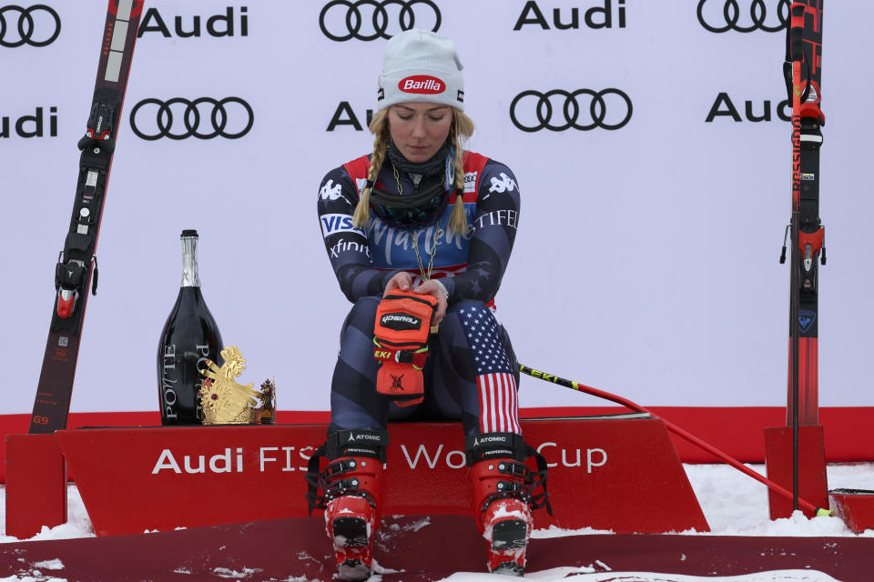 United States' Mikaela Shiffrin contemplates on the podium after winning an alpine ski, women's World Cup giant slalom, in Kronplatz, Italy, Tuesday, Jan. 24, 2023. Shiffrin won a record 83rd World Cup race Tuesday. (AP Photo/Alessandro Trovati)