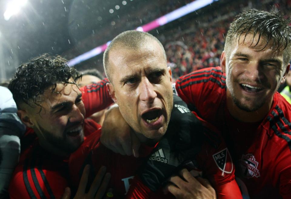 <p>Benoit Cheyrou #8 (C) of Toronto FC celebrates a goal with Jonathan Osorio #21 (L) and Nick Hagglund #6 (R) during the second half of the MLS Eastern Conference Final, Leg 2 game against Montreal Impact at BMO Field on November 30, 2016 in Toronto, Ontario, Canada. (Photo by Vaughn Ridley/Getty Images) </p>