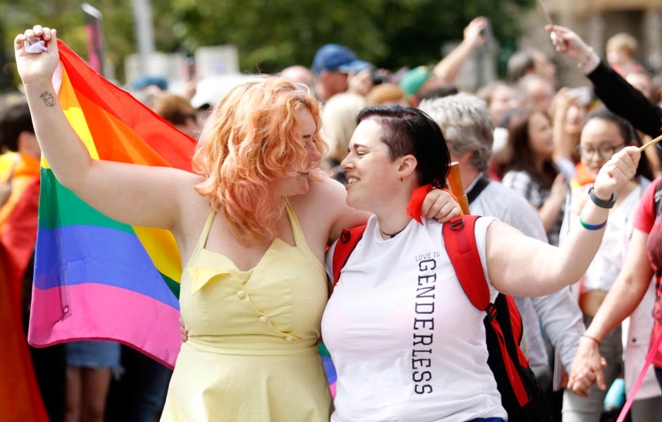 <p>Revelers take part in the Pride parade as it makes its way through the city center, in Belfast, Northern Ireland, Saturday Aug. 5, 2017. (Photo: Peter Morrison/PA via AP) </p>