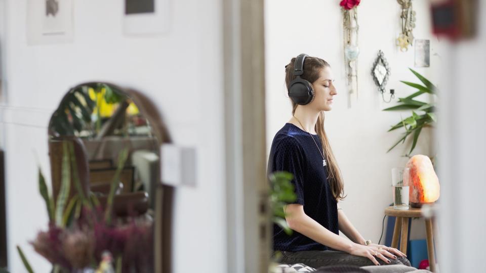 Woman meditating with heaphones