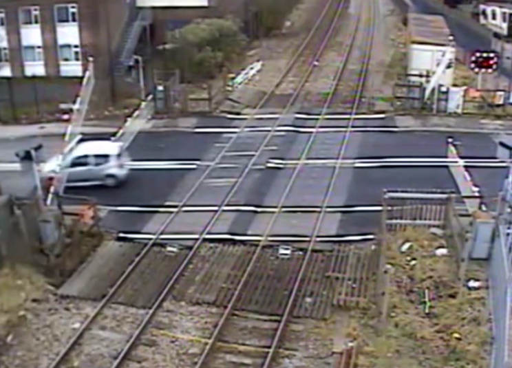 The car ducks under the second barrier just in time (Picture: Network Rail)