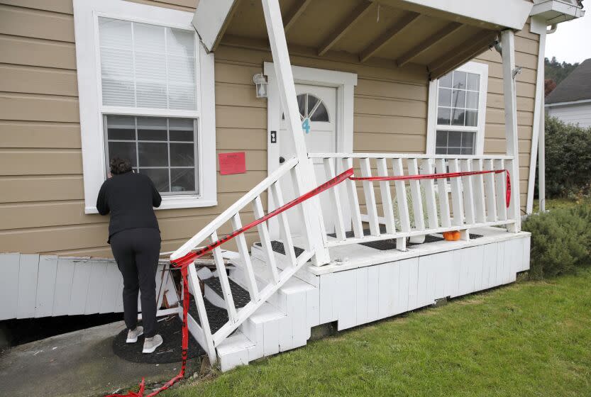 RIO DELL, CALIFORNIA - DECEMBER 21: Jacqui McIntosh peers in the window of her red-tagged damaged home in Rio Dell, Calif., on Wednesday, Dec. 21, 2022. A 6.4 magnitude earthquake struck the coastline near Eureka early Tuesday morning. (Jane Tyska/Digital First Media/East Bay Times via Getty Images)