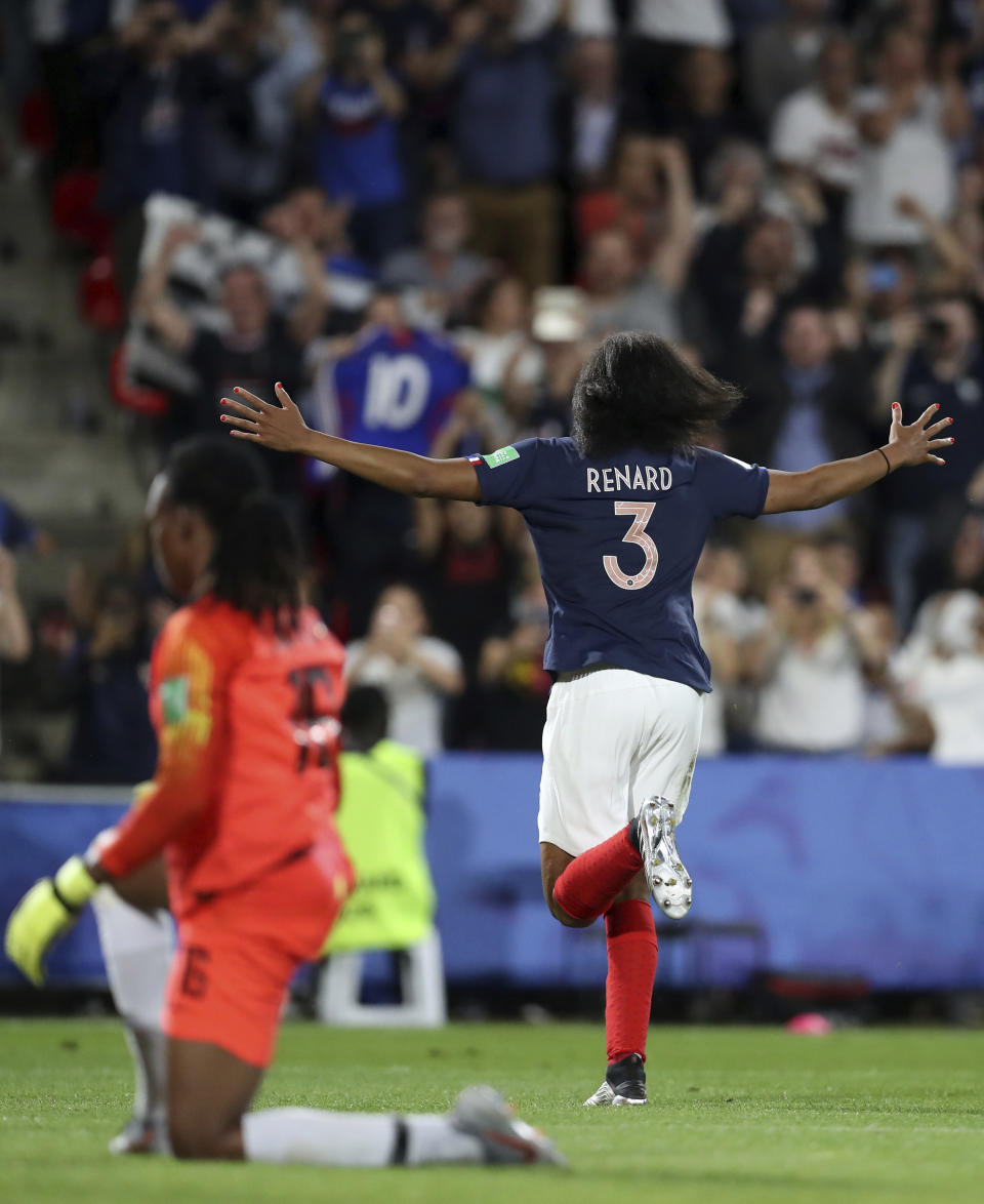 France's Wendie Renard, right, celebrates after scoring the opening goal against Nigeria goalkeeper Chiamaka Nnadozie during the Women's World Cup Group A soccer match between Nigeria and France at the Roazhon Park in Rennes, France, Monday, June 17, 2019. (AP Photo/Vincent Michel)