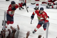 Florida Panthers left wing Matthew Tkachuk (19) reacts after scoring the game-winning goal against the Carolina Hurricanes in the waning seconds of the third period of Game 4 of the NHL hockey Stanley Cup Eastern Conference finals Wednesday, May 24, 2023, in Sunrise, Fla. At left is Panthers center Sam Reinhart (13). (AP Photo/Lynne Sladky)