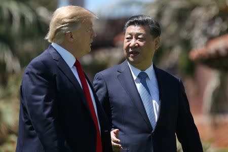 FILE PHOTO: U.S. President Donald Trump and China's President Xi Jinping chat as they walk along the front patio of the Mar-a-Lago estate after a bilateral meeting in Palm Beach, Florida, U.S., April 7, 2017. REUTERS/Carlos Barria