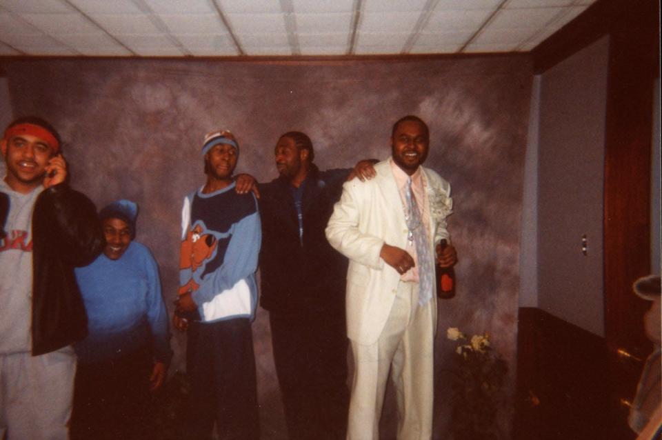 Markus Rogers, left, and Javan Rogers, right, stand with their father, Robert Allen III. The Akron brothers were killed within three months of each other in 2002. Both cases remain unsolved.