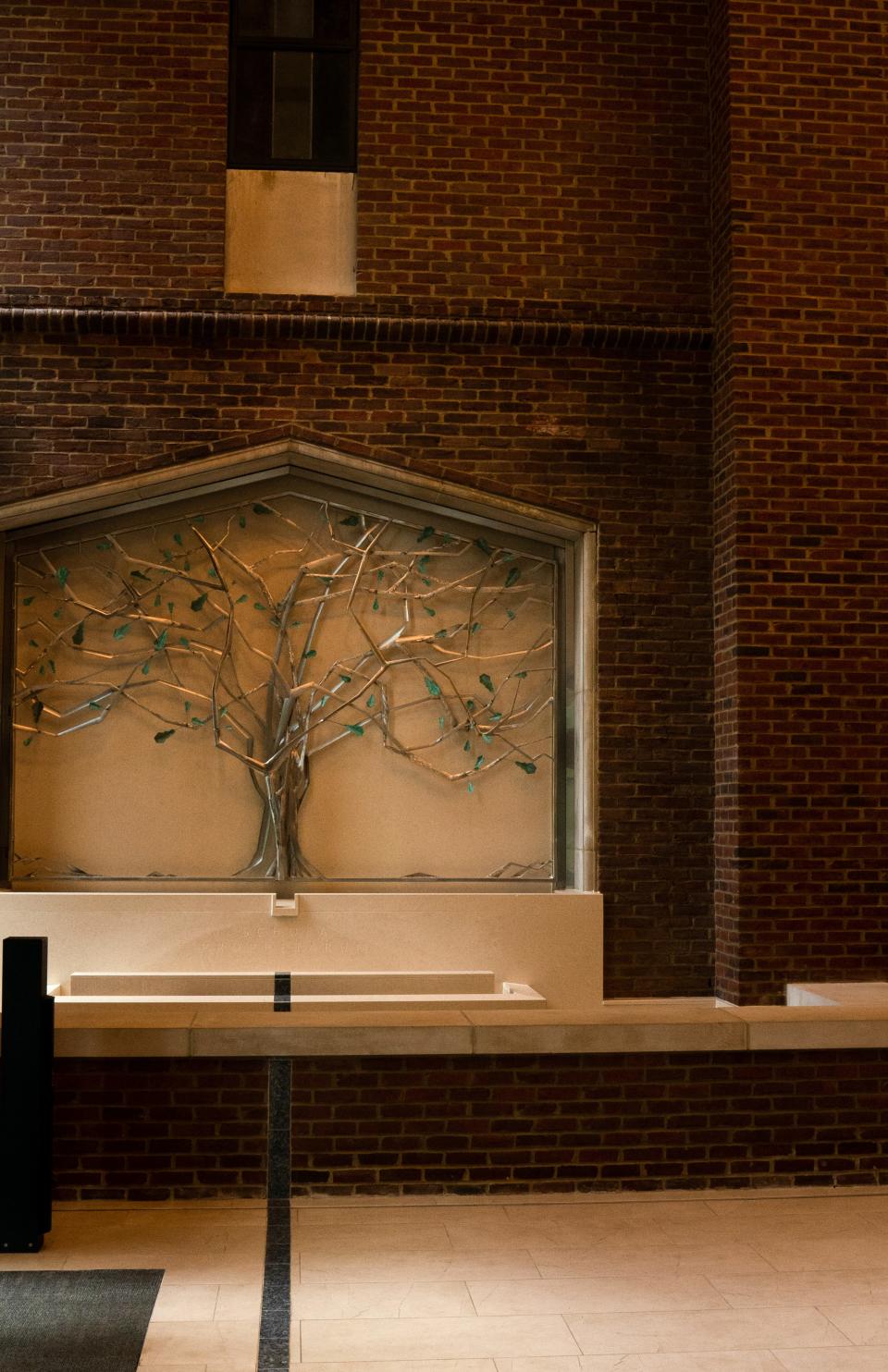 Schola Prophetarum (school of prophets) is inscribed below a tree sculpture at the entrance to Vanderbilt University Divinity School Thursday, July 6, 2023. The sculpture was created using stainless steel for the tree and salvaged copper from the building's older side entrances to make the tree's leaves.