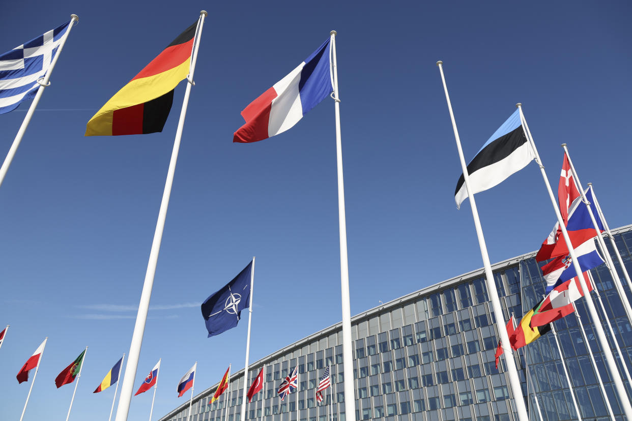 An empty flag pole stands between flags of member nations outside a meeting of NATO foreign ministers at NATO headquarters in Brussels, Tuesday, April 4, 2023. Finland is set to officially become a member of NATO later on Tuesday and take its place among the ranks of the world's biggest security alliance. (AP Photo/Geert Vanden Wijngaert)