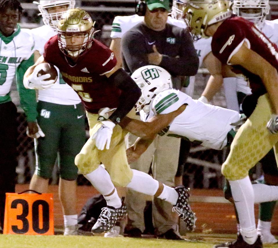 Riverdale's Brock Montgomery (6) catches a pass and carries the ball down the sidelines as Green Hill's Dallas Jackson (2) tackles him during the football playoff game at Riverdale, on Friday, Nov 3, 2023.