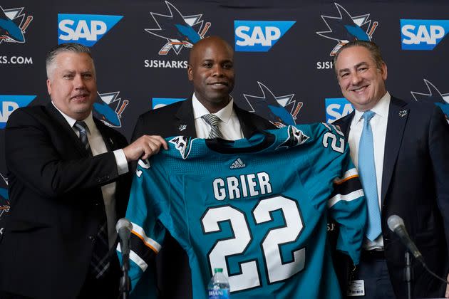 Mike Grier, middle, poses for photos with San Jose Sharks assistant general manager Joe Will, left, and president Jonathan Becher in San Jose, California on Tuesday. (Photo: Jeff Chiu via Associated Press)