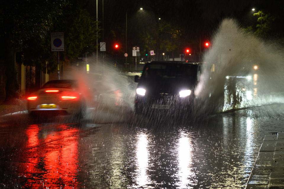 LONDON, ENGLAND - NOVEMBER 02: Vehicles negotiate a flooded section of the A1 road on November 02, 2022 in London, England. Torrential rain and flash flooding hit the region late on Wednesday evening, causing traffic jams as cars became stuck in the standing water. (Photo by Leon Neal/Getty Images)