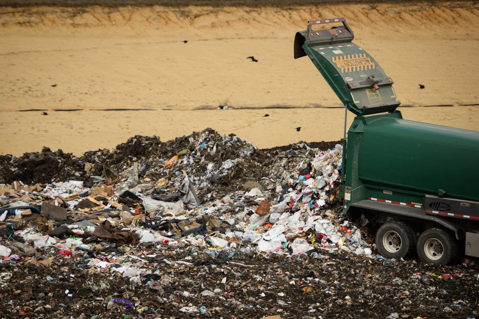 A garbage truck dumps trash at the Ann Street landfill. County and city residents are seeing increased trash fees this month.