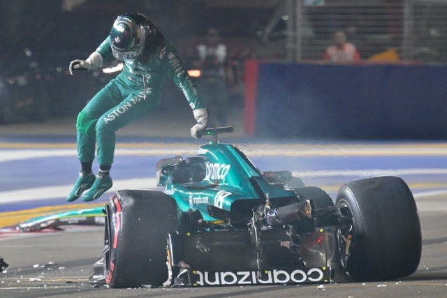 Lance Stroll jumps out from his car after his crash