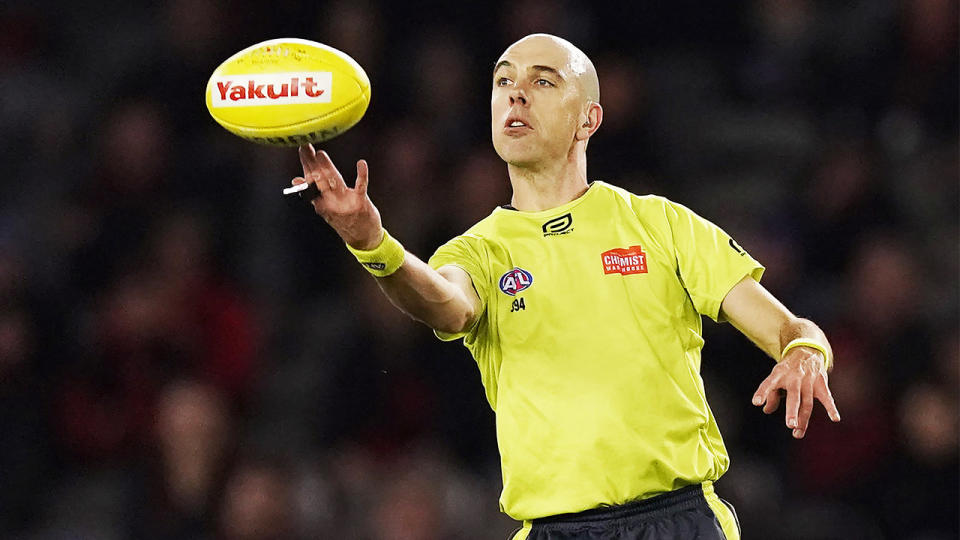 Umpire Mathew Nicholls throws up the ball during the round 15 AFL match between the Essendon Bombers and the Greater Western Sydney Giants at Marvel Stadium on June 27, 2019 in Melbourne, Australia. (Photo by Michael Dodge/Getty Images)