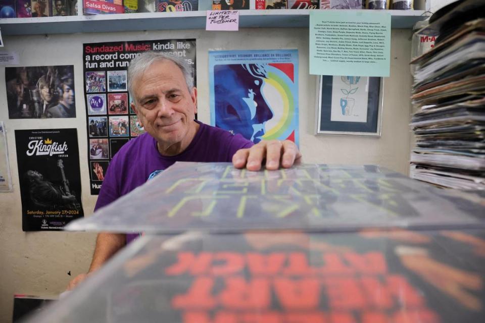 Yesterday and Today Records owner Evan Chern looks over a stack of records at his record store on west Bird Road at 9274 SW 40th St. in Miami, Florida, Feb. 2, 2024. Y&T is the oldest record store in Miami-Dade County.
