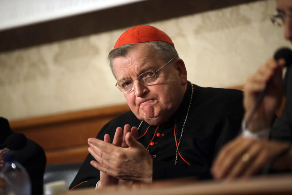 FILE - In this Thursday, Sept. 6, 2018 file photo, Cardinal Raymond Burke applauds during a press conference at the Italian Senate, in Rome. A conservative American cardinal has distanced himself from former White House adviser Steve Bannon and severed ties with a Bannon-linked institute that wants to train future populist leaders in Italy. Cardinal Raymond Burke said Tuesday, June 25, 2019 he was stepping down as honorary president of the Dignitatis Humanae Institute because “it has become more identified with the political program of Mr. Bannon.” (AP Photo/Alessandra Tarantino, file)