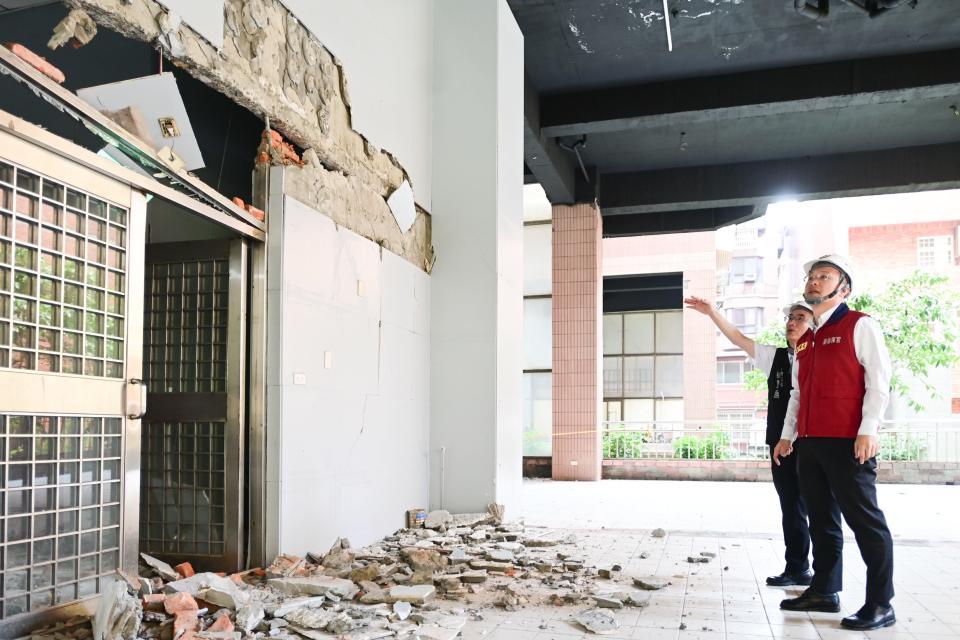 image of people looking at damaged building