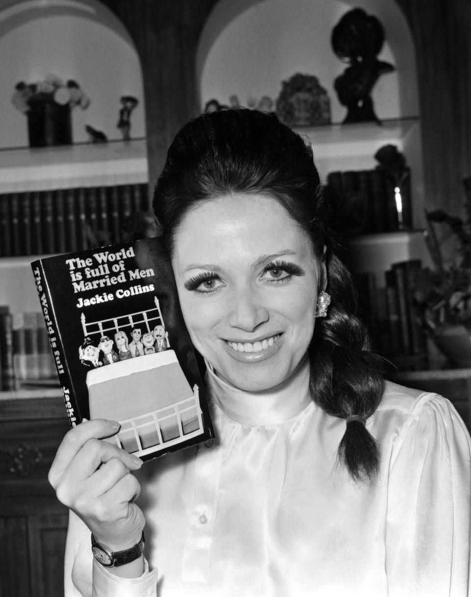 In this Feb. 12, 1968 file photo, author Jackie Collins holds her first book, “The World Is Full Of Married Men,” at her apartment in London. The author is the subject of the new documentary "Lady Boss," premiering June 10 at the Tribeca Film Festival.