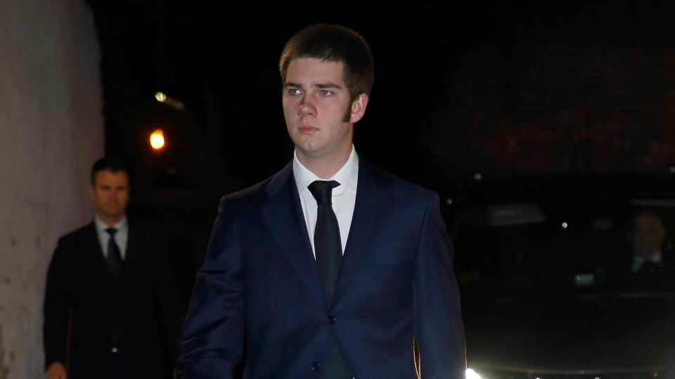 Juan Urdangarin walking in a blue suit