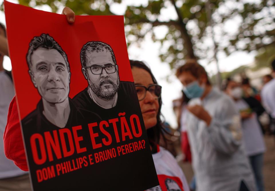 Brazilian actress Lucelia Santos takes holds a poster with the images of  British journalist Dom Phillips, left, and expert on indigenous affairs Bruno Araujo Pereira following their disappearance in the Amazon, during a protest in Copacabana beach, Rio de Janeiro, Brazil, Sunday, June 12, 2022. Federal Police and military forces are carrying out searches and investigations into the disappearance of Phillips and Pereira in the Javari Valley Indigenous territory, a remote area of the Amazon rainforest in Atalaia do Norte, Amazonas state. (AP Photo/Bruna Prado)