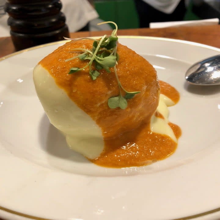 A croquette with spicy brava sauce