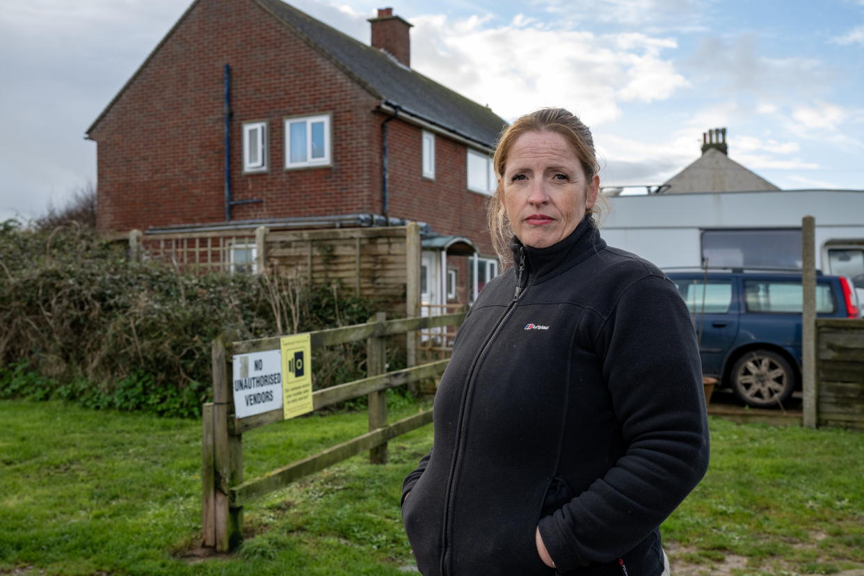 Nicola Bayless, 48, outside her home in Happisburgh, Norfolk. (SWNS)