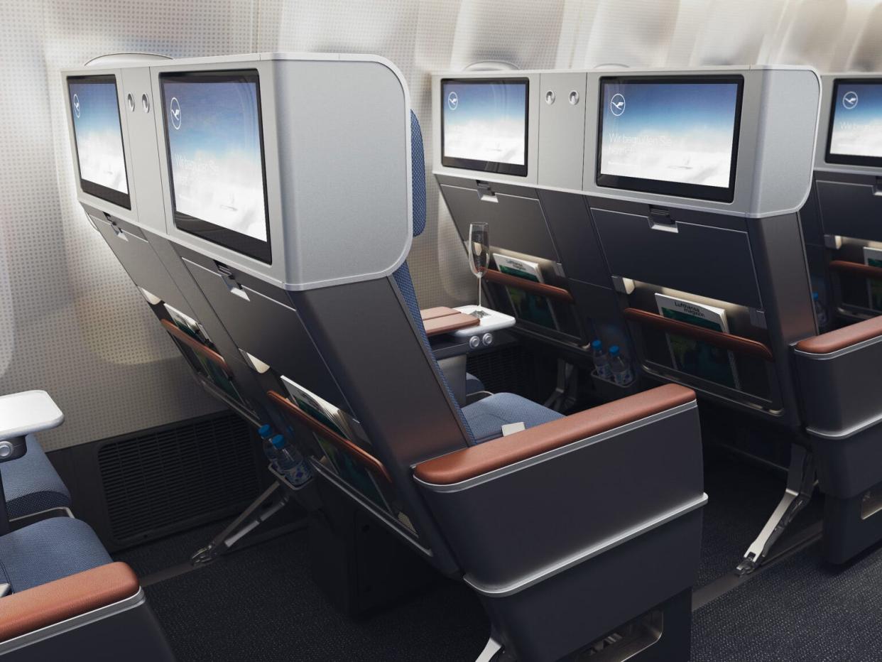 The premium economy seats included in Lufthansa's Allegris layout planes with seatback screens showing.