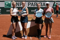 Czech Republic's Barbora Krejcikova, second left, and compatriot Katerina Siniakova, left, USA's Bethanie Mattek-Sands, second right, and Poland's Iga Swiatek hold their trophies after their women's doubles final match of the French Open tennis tournament at the Roland Garros stadium Sunday, June 13, 2021 in Paris. Czech Republic's Barbora Krejcikova playing with fellow Cezch player Katerina Siniakova, won the doubles final 6-4, 6-2. (AP Photo/Thibault Camus)