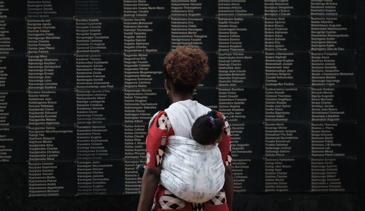 Commemorating the victims of Rwanda's 1994 genocide at a memorial in Kigali. <a href="https://www.gettyimages.com/detail/news-photo/woman-carrying-her-child-looks-at-the-wall-of-victims-names-news-photo/1135836132?adppopup=true" rel="nofollow noopener" target="_blank" data-ylk="slk:Yasuyoshi Chiba/AFP via Getty Images;elm:context_link;itc:0;sec:content-canvas" class="link ">Yasuyoshi Chiba/AFP via Getty Images</a>