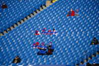Buffalo Bills fans, sitting apart, watch as their team warm up before an NFL wild-card playoff football game against the Indianapolis Colts, Saturday, Jan. 9, 2021, in Orchard Park, N.Y. (AP Photo/Jeffrey T. Barnes)