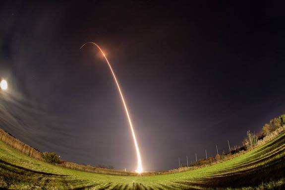 An Orbital Sciences Minotaur 1 rocket streaks toward space in this long-exposure view of the Air Force's ORS-3 mission launch of 29 small satellites from Pad 0B at the Mid-Atlantic Regional Spaceport at NASA's Wallops Flight Facility on Wallops